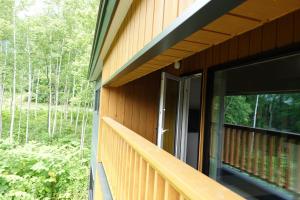 a balcony of a house with an open door at CLOUD9 - Vacation STAY 46105v in Rusutsu