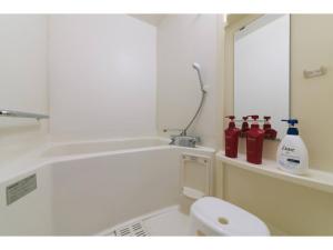 a bathroom with a white toilet and a mirror at VIEW HAKATA - Vacation STAY 87980 in Fukuoka
