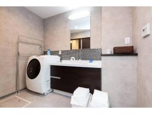 a bathroom with a sink and a large mirror at BEPPU NO YU SORA - Vacation STAY 87966 in Beppu