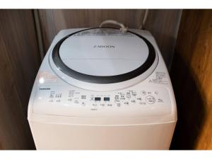 - un lave-linge avec une ligne de téléphone dans l'établissement KOTONONE MAI - Vacation STAY 87621, à Yufu