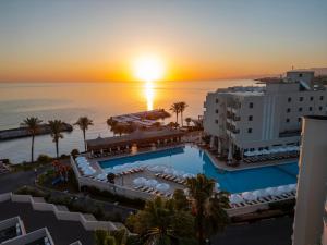 an aerial view of the hotel and the ocean at sunset at Vuni Palace Hotel & Casino & SPA in Kyrenia