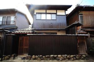 a house with a fence in front of it at Fushimi - House - Vacation STAY 88668 in Fushimi +6 photos
