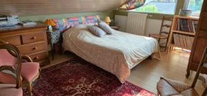 a bedroom with a bed and a dresser and a window at Chambre d'hôte - La Maison Verte in Charmes +31 photos