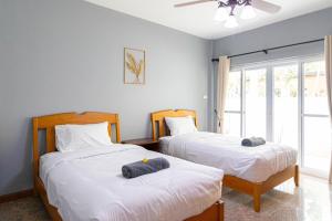 a bedroom with two beds and a window at D2 Pool Villa in Hua Hin +48 photos