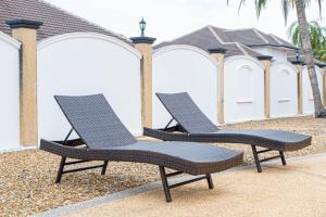 two lounge chairs sitting next to each other on a patio at D2 Pool Villa in Hua Hin