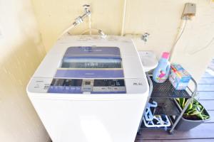 a washing machine sitting in a bathroom next to a sink at Nago - House - Vacation STAY 88505 in Nago +46 photos