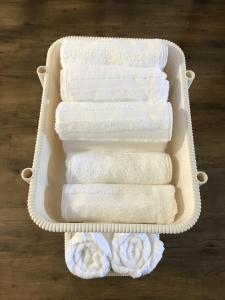 a plastic container filled with white towels on a table at It's Town Kasuga B Building - Vacation STAY 89474 in Kasuga