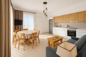 a living room and kitchen with a table and a couch at Theologos Residencies in Theologos