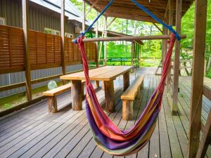 a hammock on a porch with a table and a bench at Nasu-gun - House - Vacation STAY 9032 in Anazawa