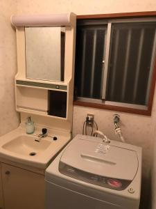 a small bathroom with a sink and a mirror at Yufu - House - Vacation STAY 89885 in Yufuin