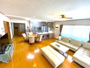 a living room with a couch and a table at Golf house - Vacation STAY 9043 in Ryūgasaki