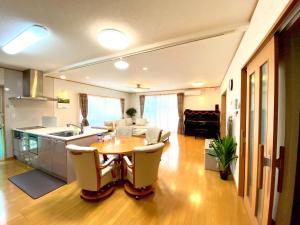 a kitchen and living room with a table and chairs at Golf house - Vacation STAY 9043 in Ryūgasaki