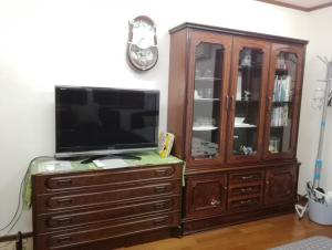 a wooden entertainment center with a television on a dresser at Sakai Kita-ku - House - Vacation STAY 10593 in Asakayamachō
