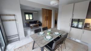 a dining table and chairs in a living room at P&M APARTMENT in Ioannina