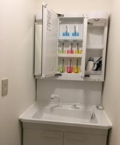 a bathroom with a sink and a cupboard at Yokohama - House - Vacation STAY 9002 in Yokohama