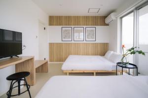 a bedroom with two beds and a tv at 257-1 - Vacation STAY 91246 in Jima