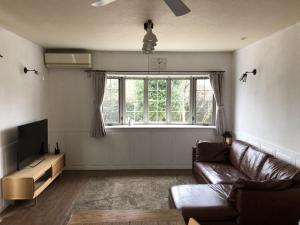 a living room with a couch and a large window at Sumoto - House - Vacation STAY 91396 in Sumoto