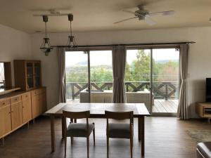 a kitchen with a table and chairs and a large window at Sumoto - House - Vacation STAY 91396 in Sumoto