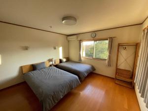 a bedroom with two beds and a window at Sumoto - House - Vacation STAY 91396 in Sumoto