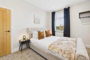a bedroom with a white bed and a window at Host & Stay - Jomor House in Burnhope