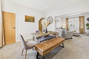a living room with a dining room table and chairs at Host & Stay - Jomor House in Burnhope