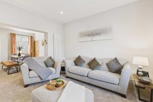 a living room with two couches and a table at Host & Stay - Jomor House in Burnhope +12 photos