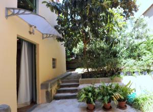 a stairway leading to a building with trees and plants at Acacia Firenze Apartments Artemisia-Angelica in Florence