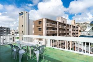 a table and chairs on the roof of a building at ASAHI HOUSE 2nd floor - Vacation STAY 92921 in Naha