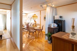 a kitchen and a living room with a dining room table at ASAHI HOUSE 2nd floor - Vacation STAY 92921 in Naha