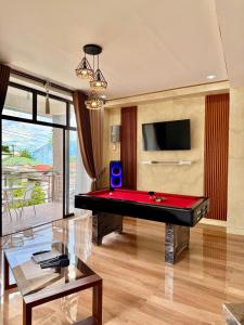 a living room with a pool table and a tv at Entire Home in Pampanga in San Fernando