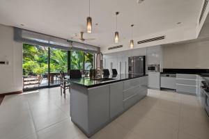 a large kitchen with a large island in the middle at Sila Ananda 6BR Pool Villa Đảo Xanh Đà Nẵng in Da Nang