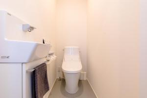 a small bathroom with a toilet and a sink at Frame view -east- - Vacation STAY 94084 in Azagawa +20 photos