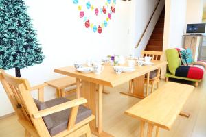 a wooden table and chairs in a room with a christmas tree at Sun River Annex Inaho - Vacation STAY 95961 in Kita-hamachō