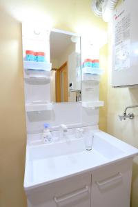 a bathroom with a white sink and a mirror at Sun River Annex Inaho - Vacation STAY 95961 in Kita-hamachō +21 photos