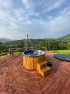 a hot tub sitting on top of a wooden deck at 650m n.p.m. in Zawoja