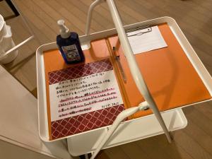 an orange suitcase with a bottle on top of it at Sudomari Akariya - Vacation STAY 68896v in Tanabe