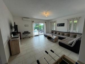 a living room with a couch and a table at Villa ISA 4 bedrooms, 4 bathrooms, sauna, jacuzzi, panoramic view in Vrh