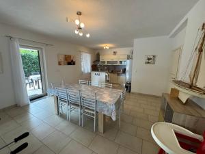 a kitchen with a table and chairs in a room at Villa ISA 4 bedrooms, 4 bathrooms, sauna, jacuzzi, panoramic view in Vrh
