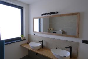 a bathroom with two sinks and a mirror at Červene maky - red poppies in Malý Slavkov