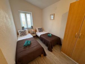 a small room with two beds and a window at Villa ISA 4 bedrooms, 4 bathrooms, sauna, jacuzzi, panoramic view in Vrh +21 photos