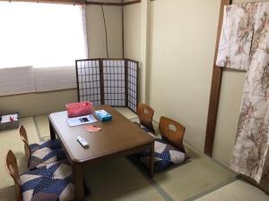 a room with a table and chairs and a window at Masaru House - Vacation STAY 9439 in Osaka
