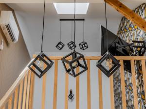 a group of lights hanging from a staircase at The Old Townhouse II in Krosno