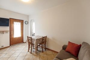 a living room with a table and a couch at Dolomitihouse CASTAGNER in Fiera di Primiero +34 photos