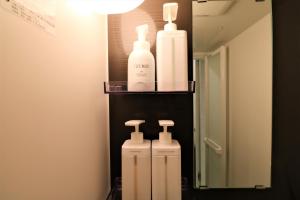 a bathroom with two bottles of soap and a mirror at Smart Stay Ito 302 - Vacation STAY 98471 in Ito +31 photos