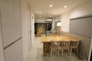 a dining room and living room with a table and chairs at Smart Stay Ito 302 - Vacation STAY 98471 in Ito