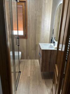 a bathroom with a sink and a toilet and a mirror at Casa Rural Villa Ribatejada in Ribatejada +25 photos