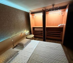 a small bedroom with a bed and a closet at Apart Burel 56 in Sofia