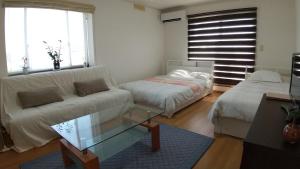 a living room with a couch and a coffee table at Guest House Mulberry - Vacation STAY 9580 in Kirishima