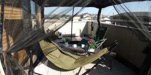 a balcony with a hammock and a table at Guest House Mulberry - Vacation STAY 9580 in Kirishima