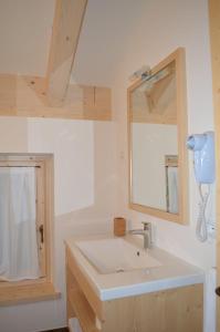 a bathroom with a sink and a mirror at Chalet Serena in Roncegno